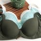 tres sutias nas cores verde azul com estampa de flores e branco com pequeno vaso de plantas perto